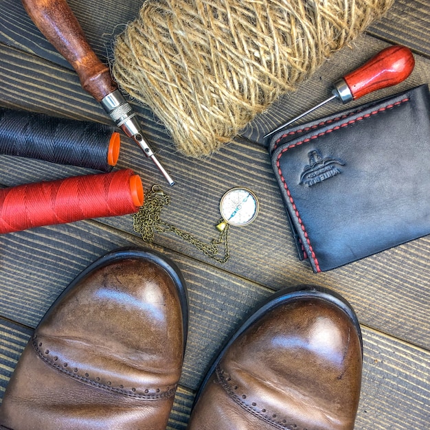 A close-up of a craftsman meticulously stitching a designer shoe, surrounded by luxury leathers and tools, illustrating high-quality production costs impacting prices.