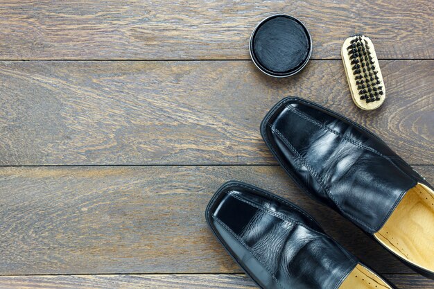 A detailed flat lay of various designer shoe care products, including polishes, brushes, and shoe trees, emphasising the importance of maintenance for investment.