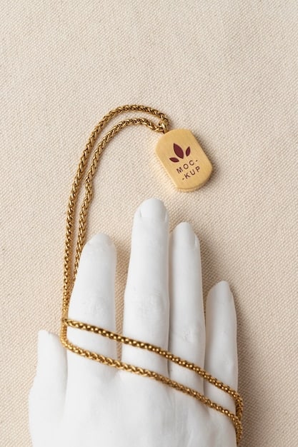 A delicate 22K gold necklace with a subtle pendant resting on a smooth, understated fabric. The gold has a rich, warm glow, highlighting its luxurious and pure quality.