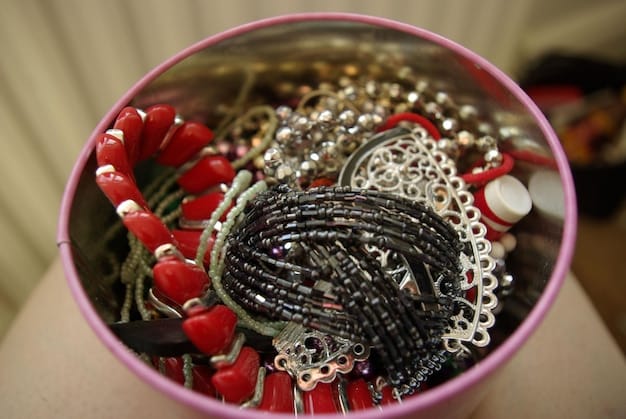 A neatly organized jewelry box with velvet-lined compartments, showcasing various fashion jewelry pieces like necklaces, earrings, and bracelets, each in its own section.
