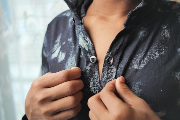 A person gently wiping down a necklace with a soft, lint-free microfiber cloth, emphasizing the importance of regular cleaning for jewelry maintenance.