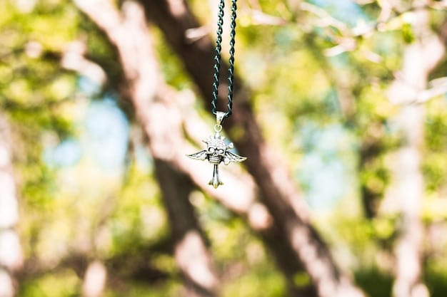 A delicate pendant necklace featuring a lab-grown diamond surrounded by recycled gold, showcasing sustainable and ethical jewelry practices, with a blurred natural background.