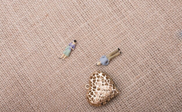 A top-down view of different types of fashion jewelry pieces arranged on a velvet tray, illustrating a range of price points. Some pieces are simple and elegant, while others display intricate designs with varied metal finishes.