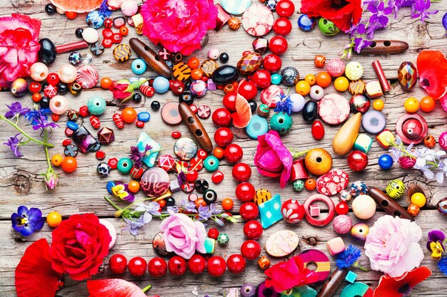 A flat lay of various fashion jewelry pieces, including brightly colored beaded necklaces, large statement earrings, and stacks of bangles, all artfully arranged to showcase their variety and playful nature.