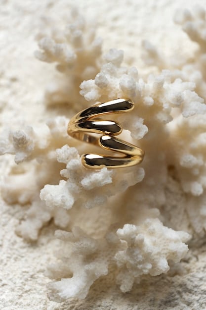 A close-up shot of a minimalist gold ring from Pistachio & Pearl, crafted from recycled gold with a subtle, repurposed pearl, highlighting its delicate design and ethical origin.