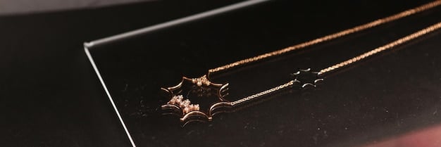 A close-up of a delicate, layered gold necklace with tiny celestial charms and a pair of matching stud earrings, displayed elegantly on a velvet jewelry stand.