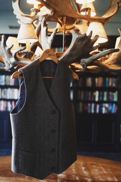 A neatly organized closet with high-quality, classic clothing items (cashmere sweaters, tailored blazers, silk blouses) on wooden hangers, showcasing a sophisticated and lasting wardrobe.