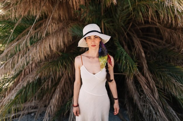 A woman wearing a stylish wide-brim straw hat, a light linen dress, and sunglasses, lounging by a crystal-blue swimming pool, with palm trees in the background.