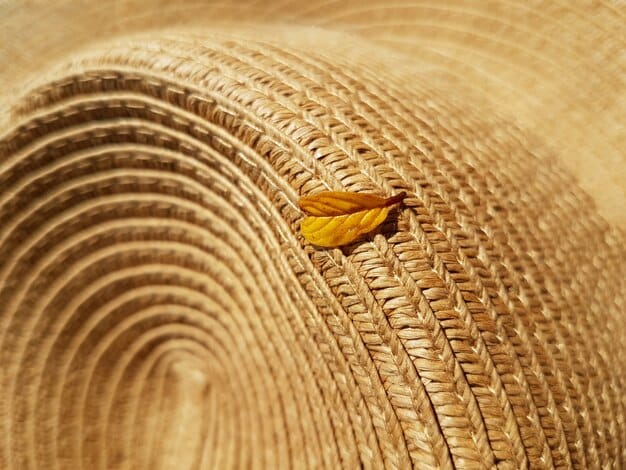 Close-up of a tightly woven Panama hat on a rustic wooden table, showcasing the intricate straw texture and a simple black ribbon band, with soft focus on a summery outdoor setting in the background.