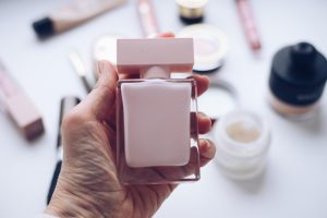 a eperson holding free perfumes samples.