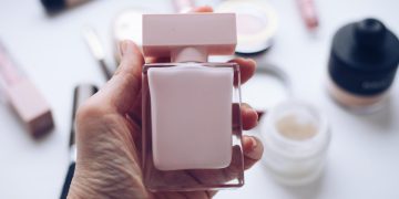 a eperson holding free perfumes samples.